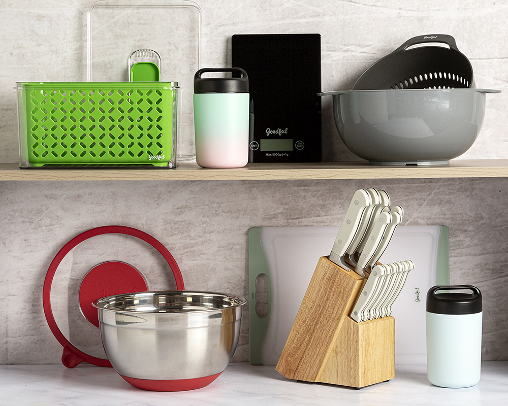 Goodful kitchen tools and gadgets styled on a shelf with knife block, colander and mixing bowls