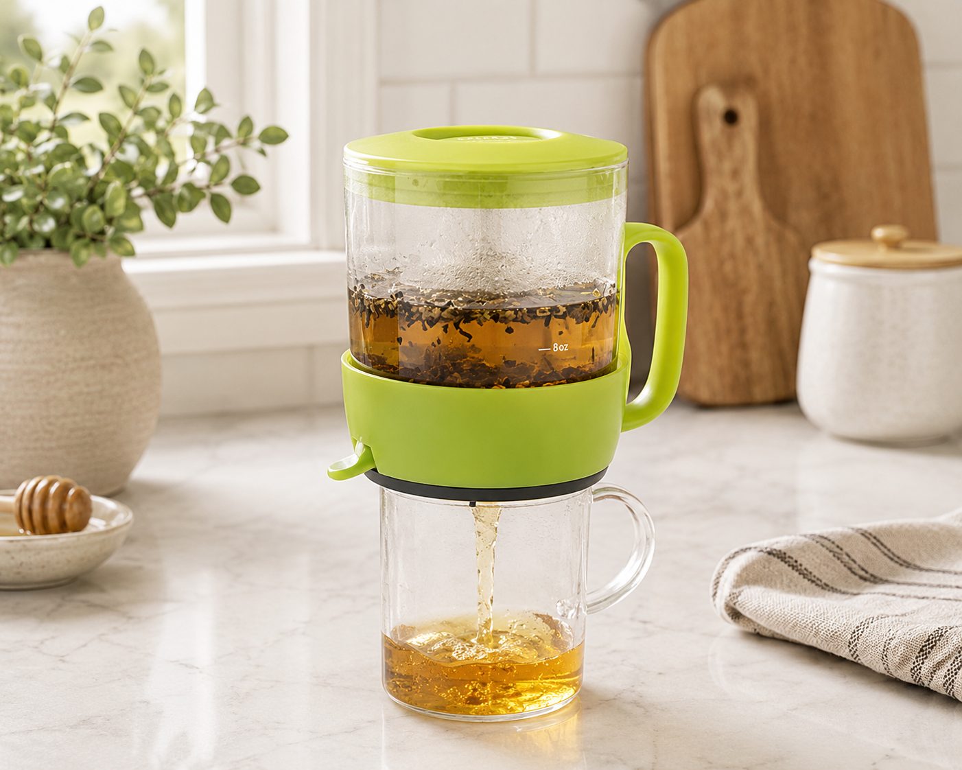 Addison glass tea steeper draining freshly brewed loose leaf tea into a glass mug