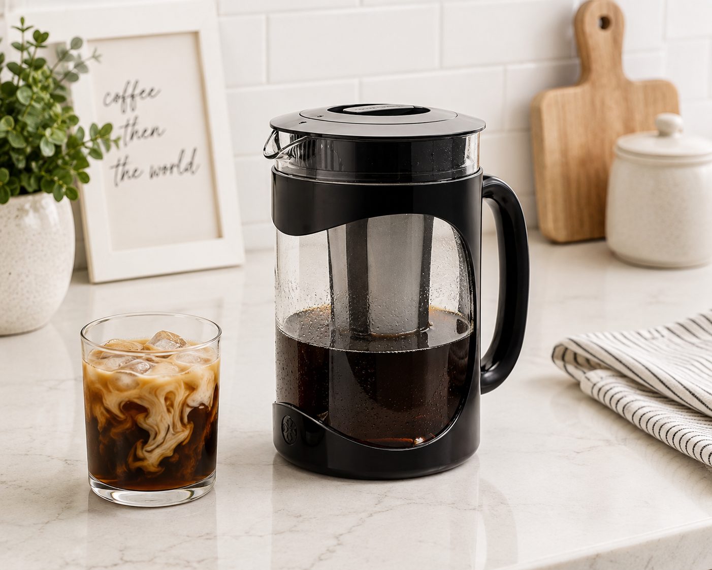 Burke cold brew coffee maker on a counter beside a glass of iced coffee