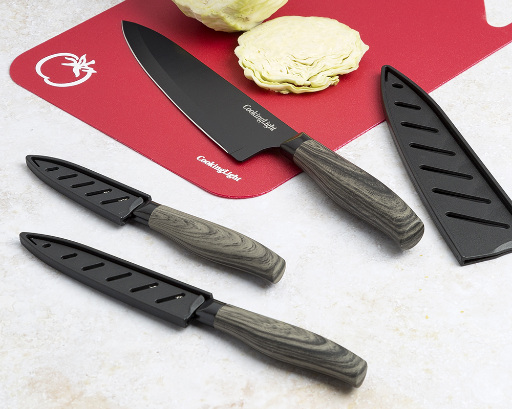 Cooking Light knives with water-transfer handles on a red cutting board