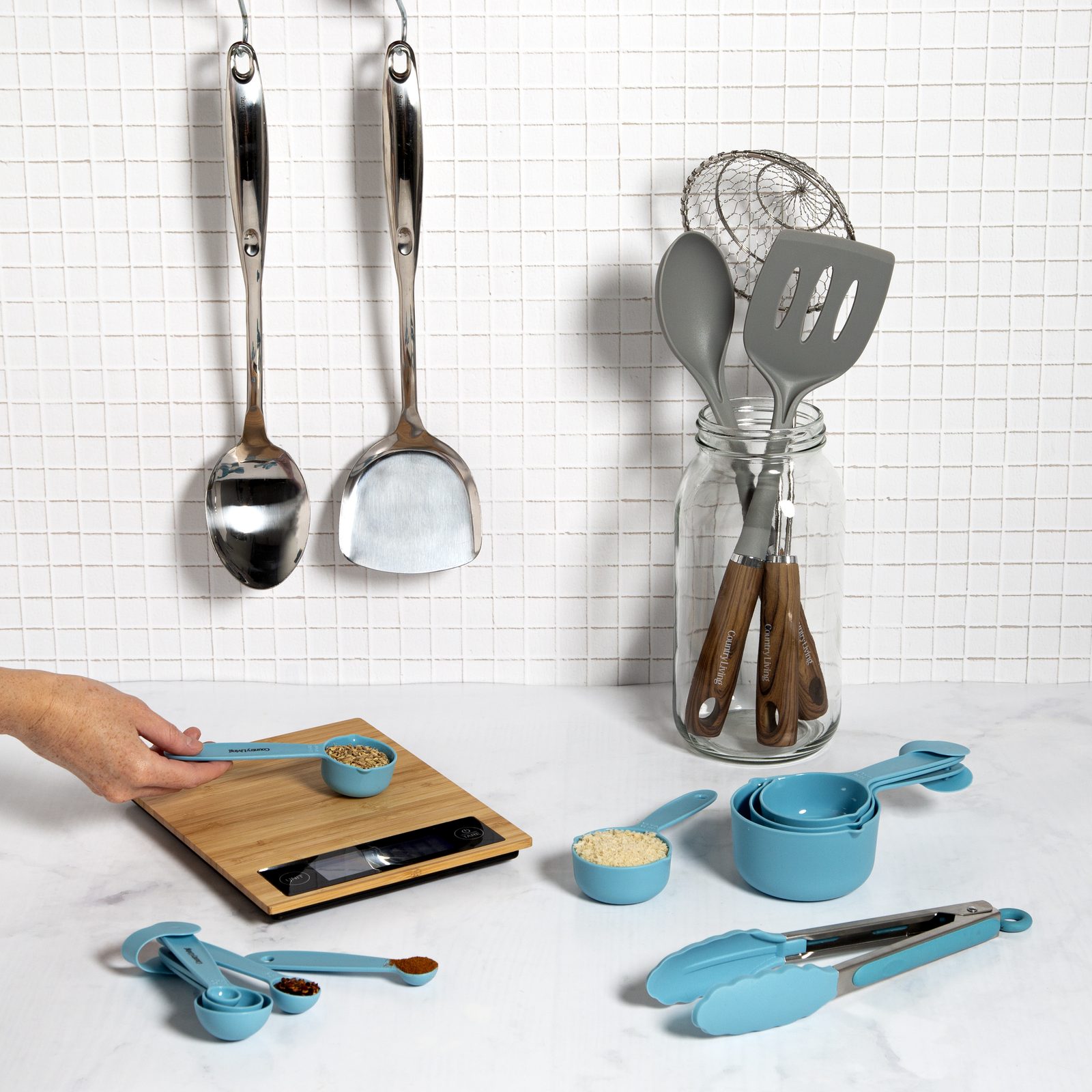 Country Living utensils on a rail, digital kitchen scale in use and teal measuring spoons