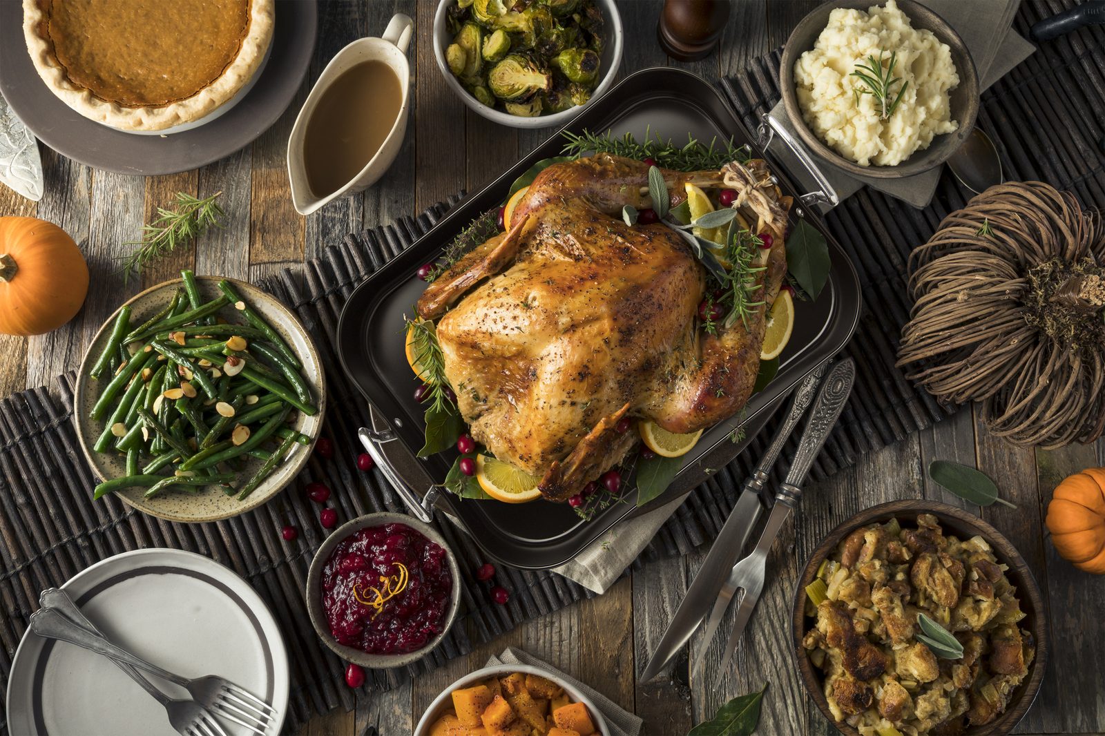 Ecolution roaster on a Thanksgiving table with turkey, green beans, cranberry and stuffing