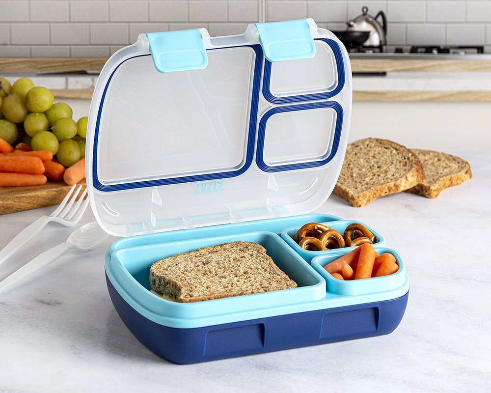 Tasty bento lunch container packed with a sandwich, fruit and vegetables