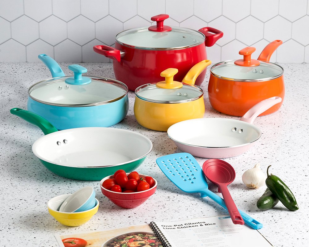Tasty multicolor ceramic cookware set with utensils and a recipe book