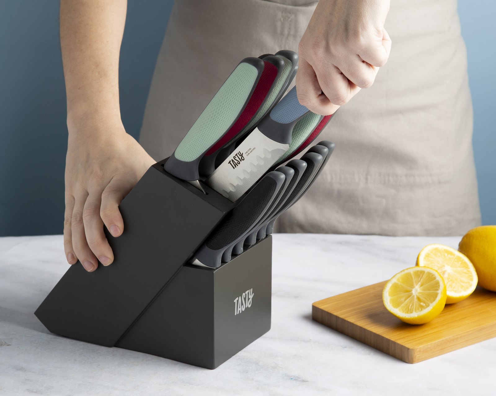 Tasty knife being drawn from its block on a marble counter